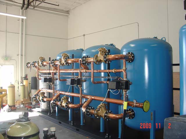 A row of blue tanks with copper pipes in a room taken in 2008