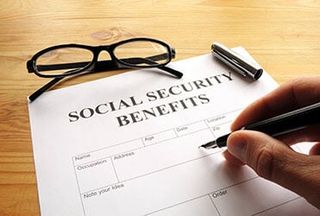Hand filling out paperwork — Social security attorney in Portland, ME Hand filling out paperwork — Social security attorney in Portland, ME
