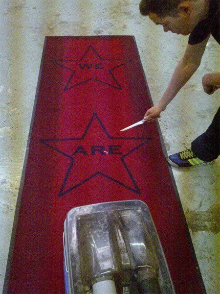 Cleaner carrying out work on a red rug