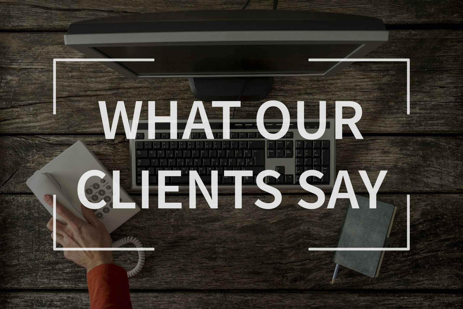 a person is holding a telephone in front of a computer screen that says what our clients say