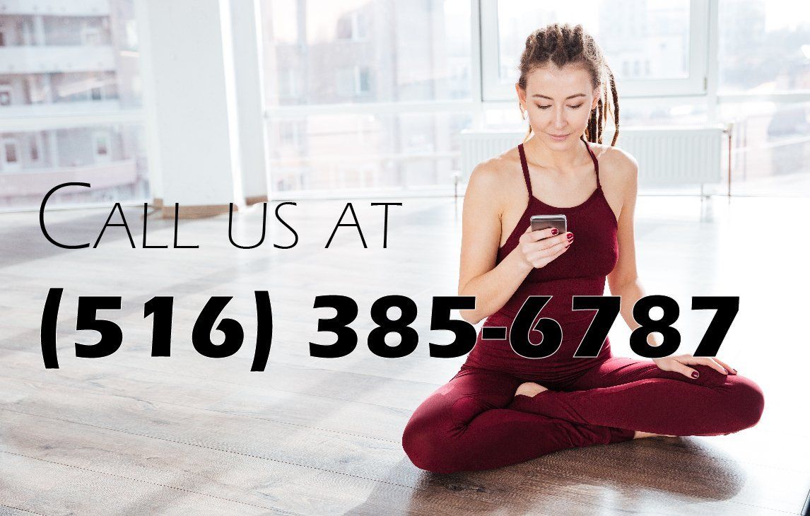 a woman is sitting on the floor looking at her phone with the number 516 385-6789 below her