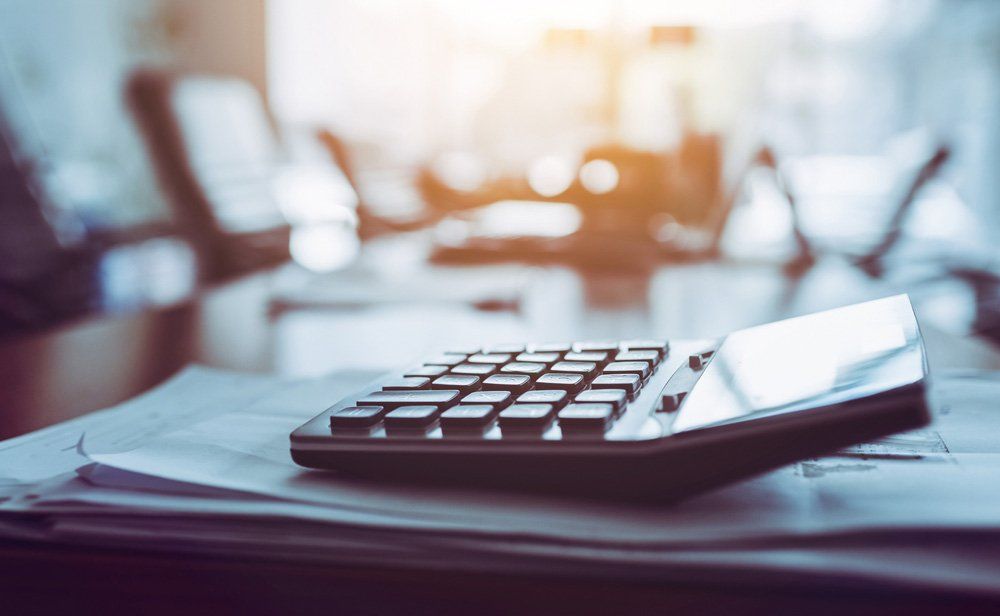 Calculator On Table — Merrick, NY — On Point Land Services Corporation