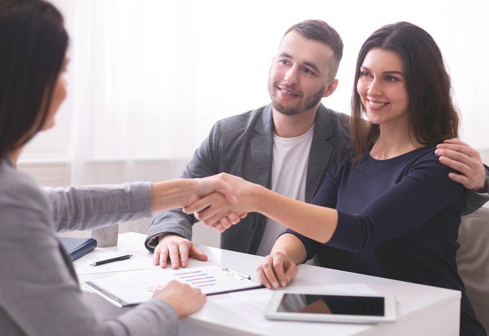 Couple Having Insurance Meeting — Merrick, NY — On Point Land Services Corporation Couple Having Insurance Meeting — Merrick, NY — On Point Land Services Corporation