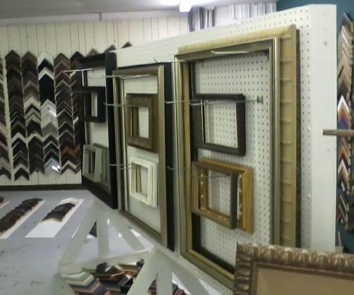 custom picture frames hanging on hooks on wall
