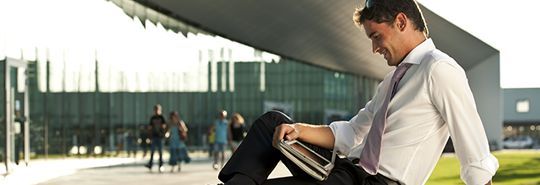 Man looking at Ipad - Accounting Solutions CQ