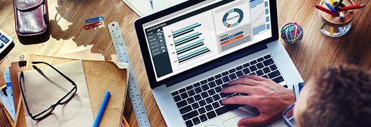 Man looking at laptop - Accounting Solutions CQ