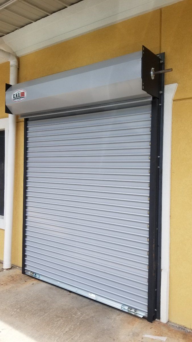 A garage door is sitting on the side of a building.