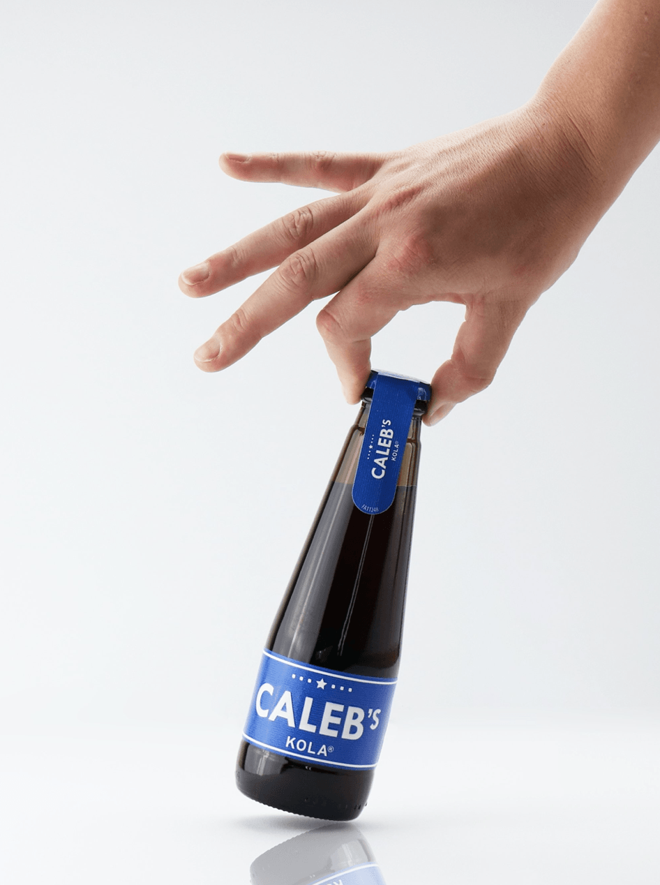 Een hand houdt een fles Caleb's 2014 vast