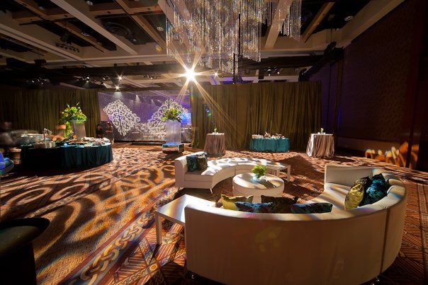 A large room filled with furniture and tables and a chandelier.