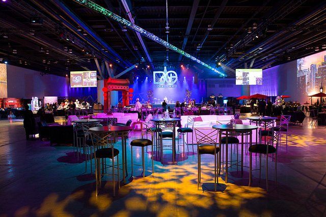 A large room with tables and chairs set up for a party.