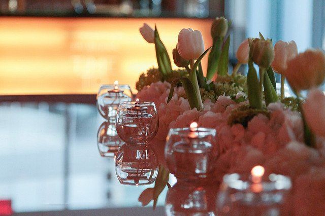 A table with flowers and candles on it