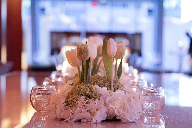 A long table with flowers and candles on it