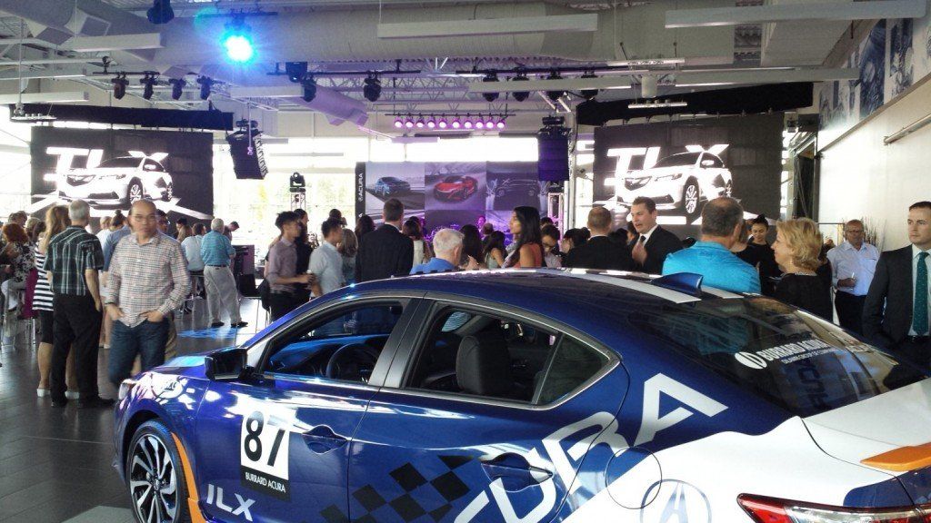 A group of people are standing around a race car with the number 81 on it