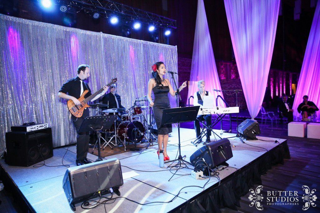 A group of people are playing instruments on a stage.