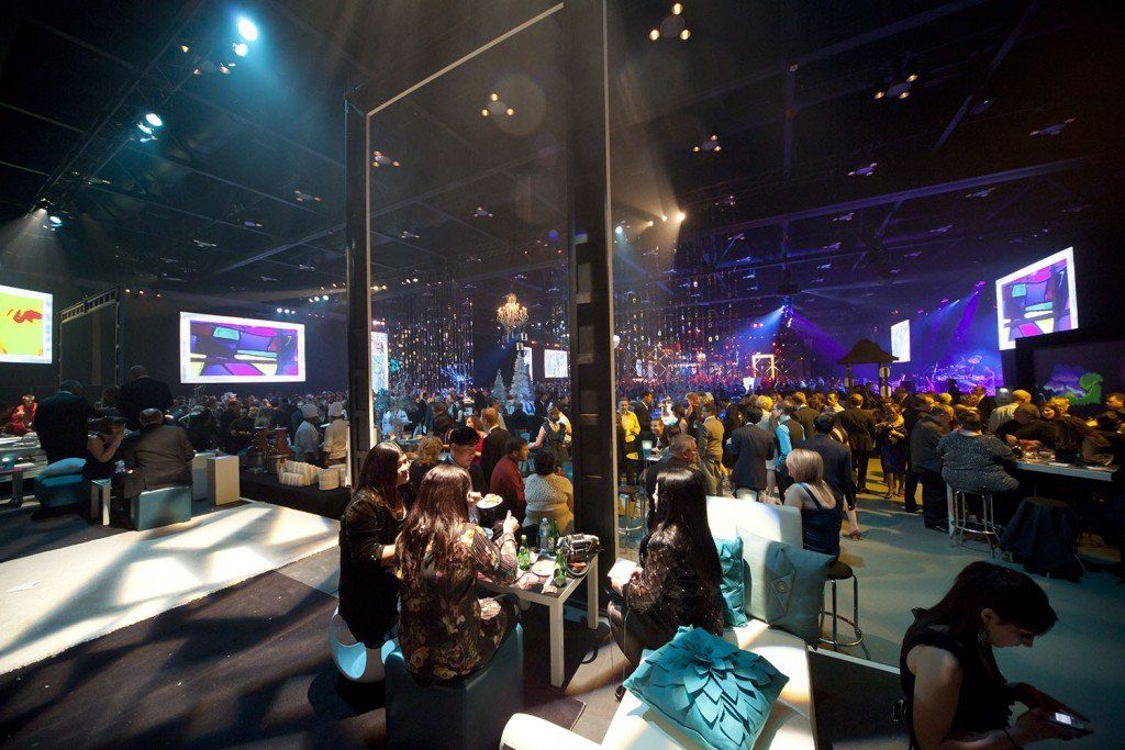 A crowd of people are gathered in a large room