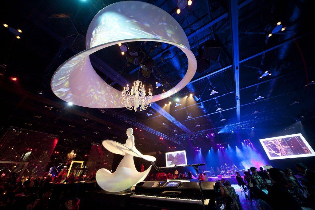 A concert with a large circle hanging from the ceiling