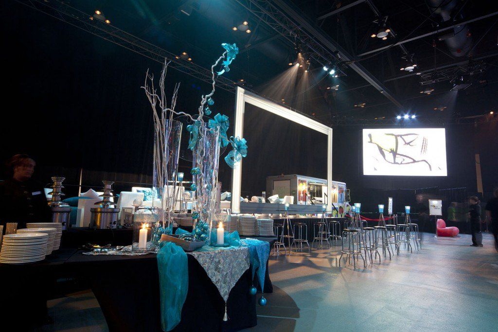 A large room with tables and a large screen
