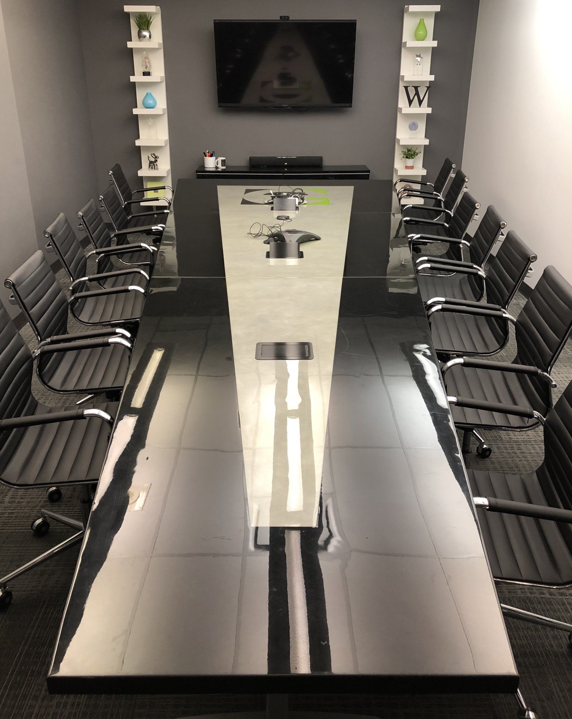 A conference room with a long table and chairs