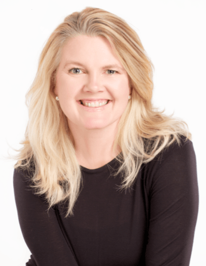 A woman with blonde hair is wearing a black shirt and smiling