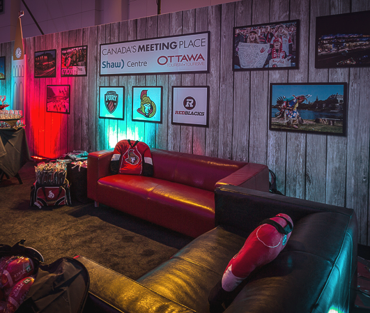 A living room with a red couch and a sign that says ottawa