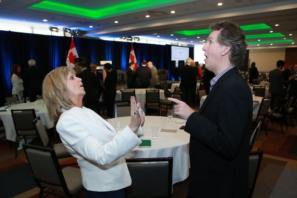 A man and a woman are standing next to each other in a room.