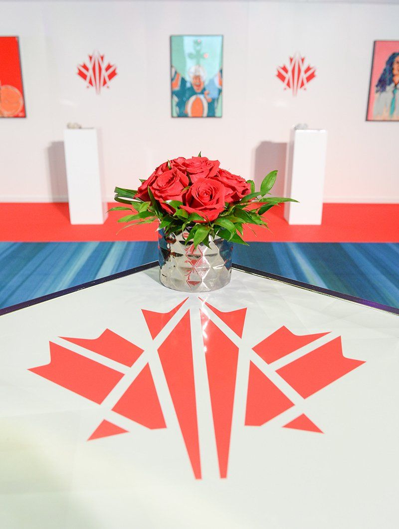 A vase of red roses sits on a table
