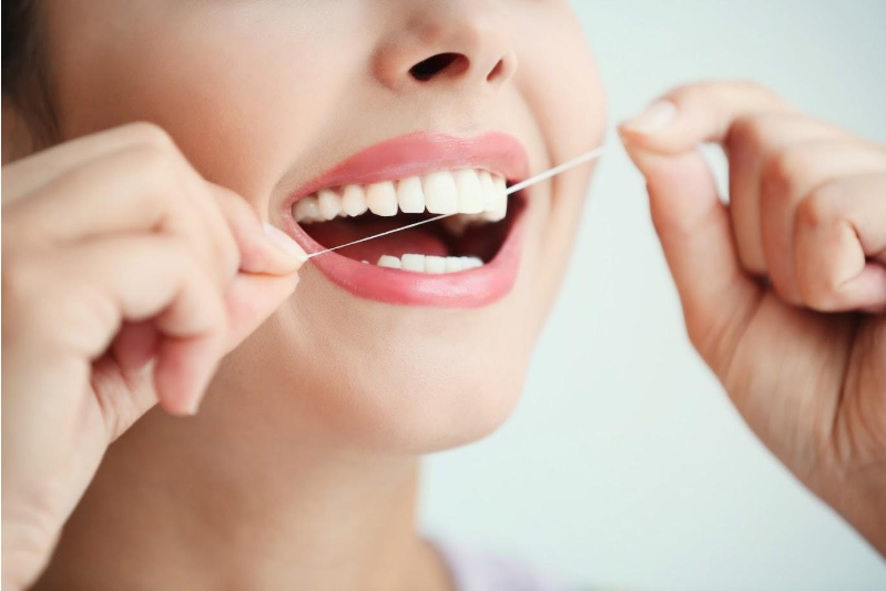 Woman Using Dental Floss — Sarasota, FL — Rutherford Gregory S DDS
