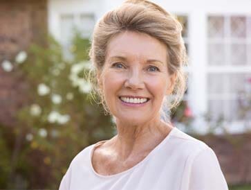 Dentist Office — Smiling Senior Citizen in Sarasota, FL A woman who received dentures in Sarasota, FL