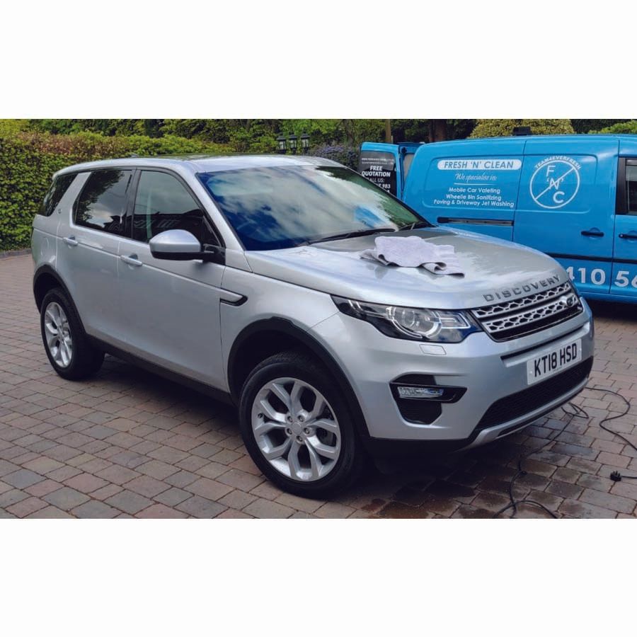 clean car with company van in the background
