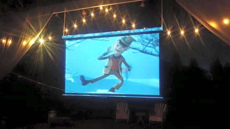 A projector screen shows a cartoon of a man in a top hat