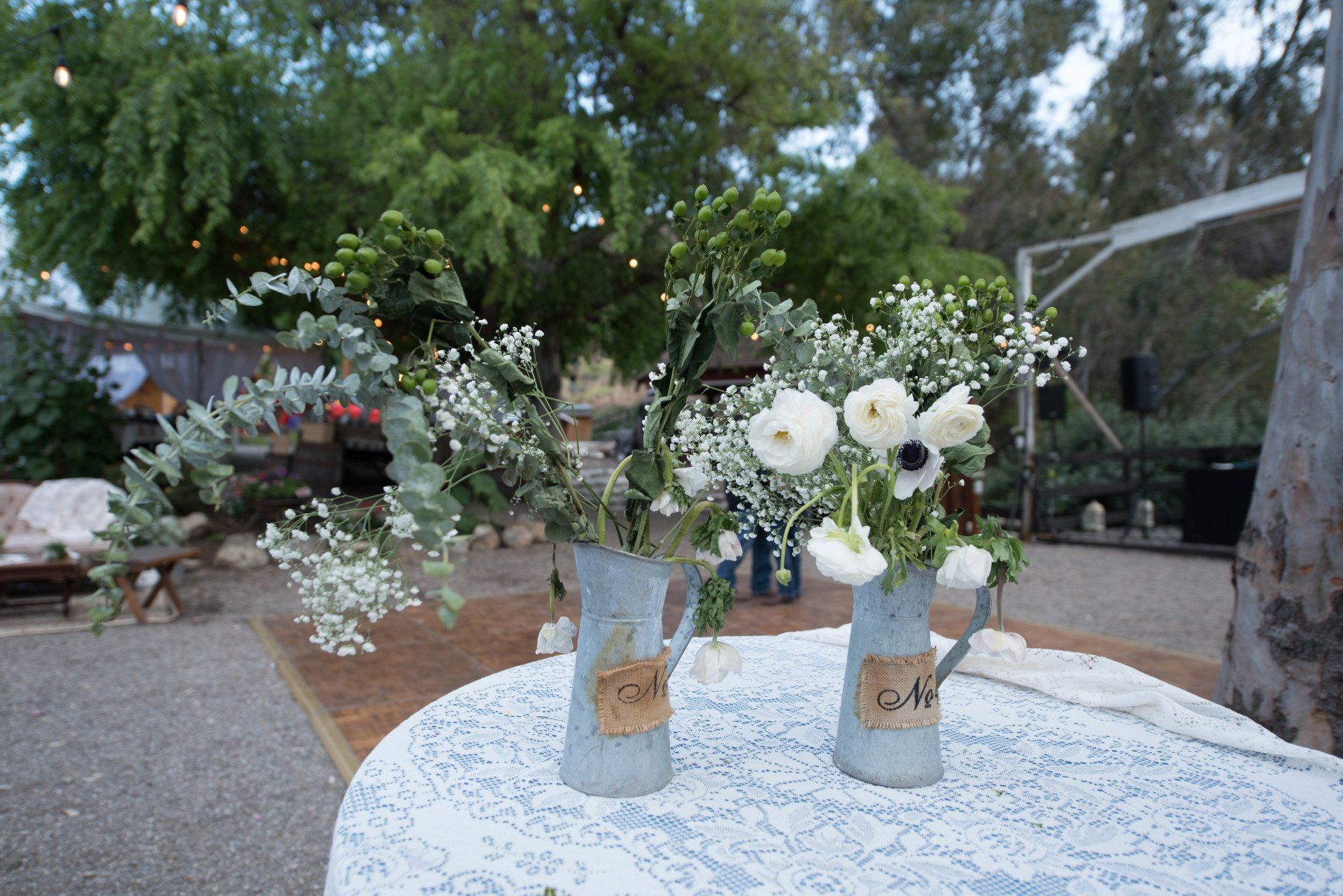 Two vases filled with flowers are sitting on a table.