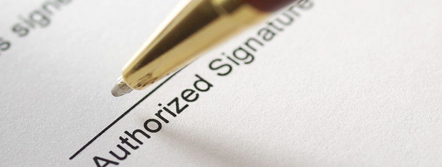 Pen signing a document