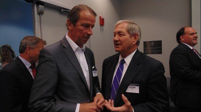 Two men in suits and ties are talking to each other
