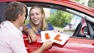 A woman holding L sign