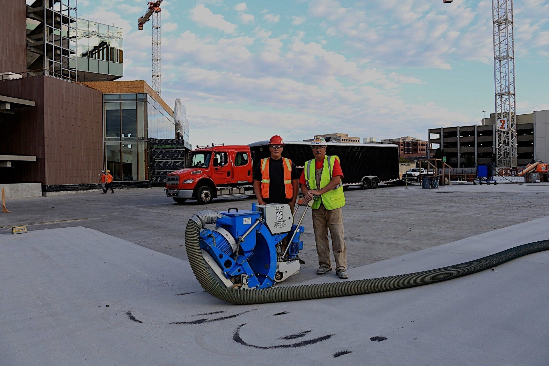 two workers doing shot blasting on concrete surface in Oregon City, OR
