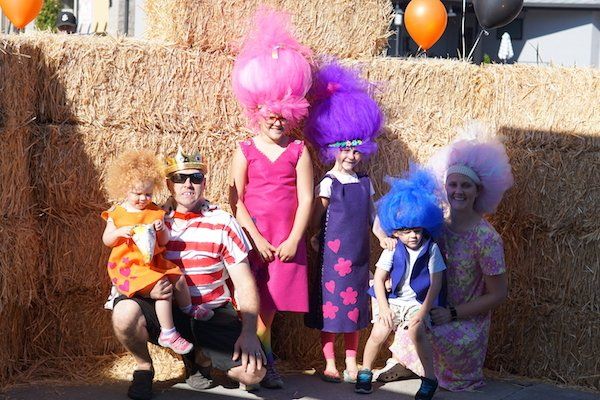 A group of people dressed in troll costumes are posing for a picture
