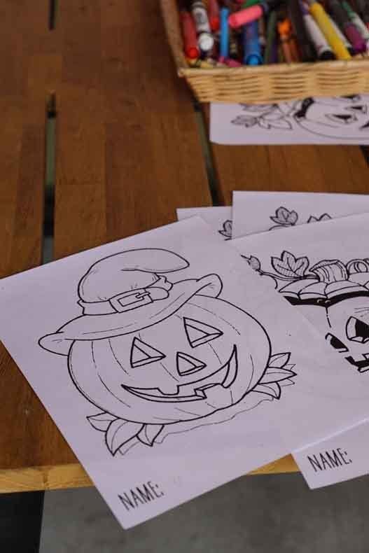 A drawing of a pumpkin wearing a witch hat