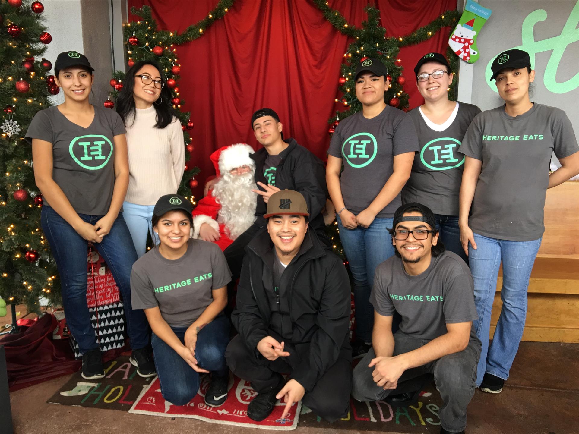 A group of people are posing for a picture with santa claus.