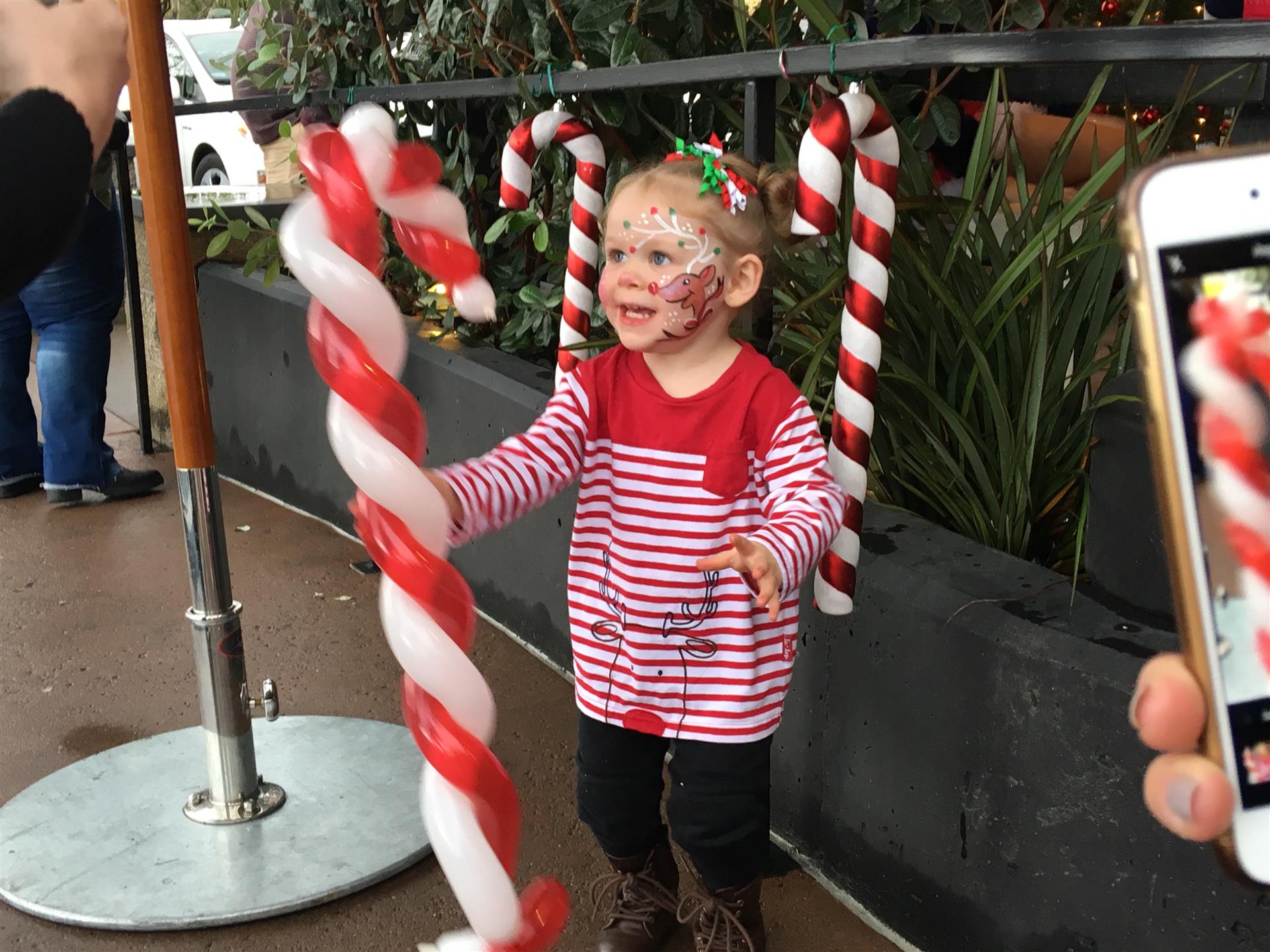 A little girl with candy canes painted on her face