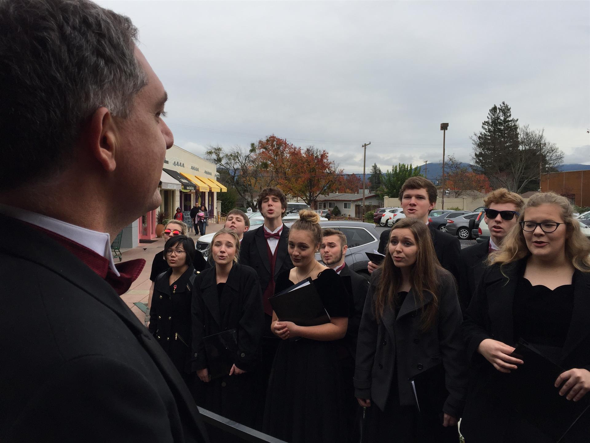 A man in a suit is talking to a group of people