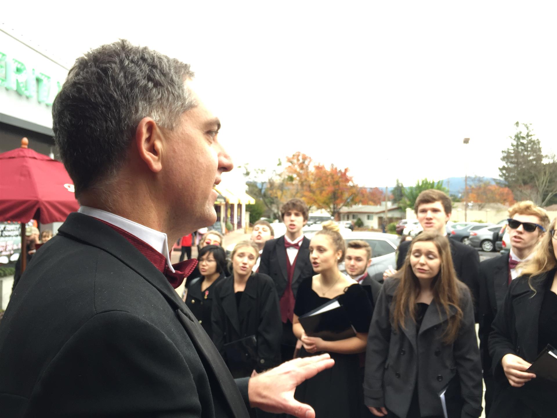 A man in a suit is talking to a group of people