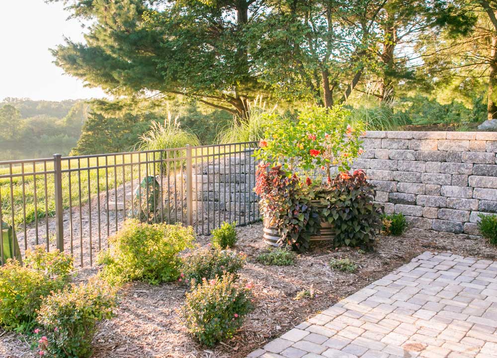 backyard planted flowers and rock bed