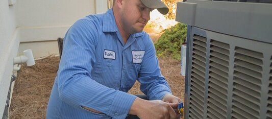 Man Fixing HVAC — Heating Service in Knoxville, TN Man Fixing HVAC — Heating Service in Knoxville, TN