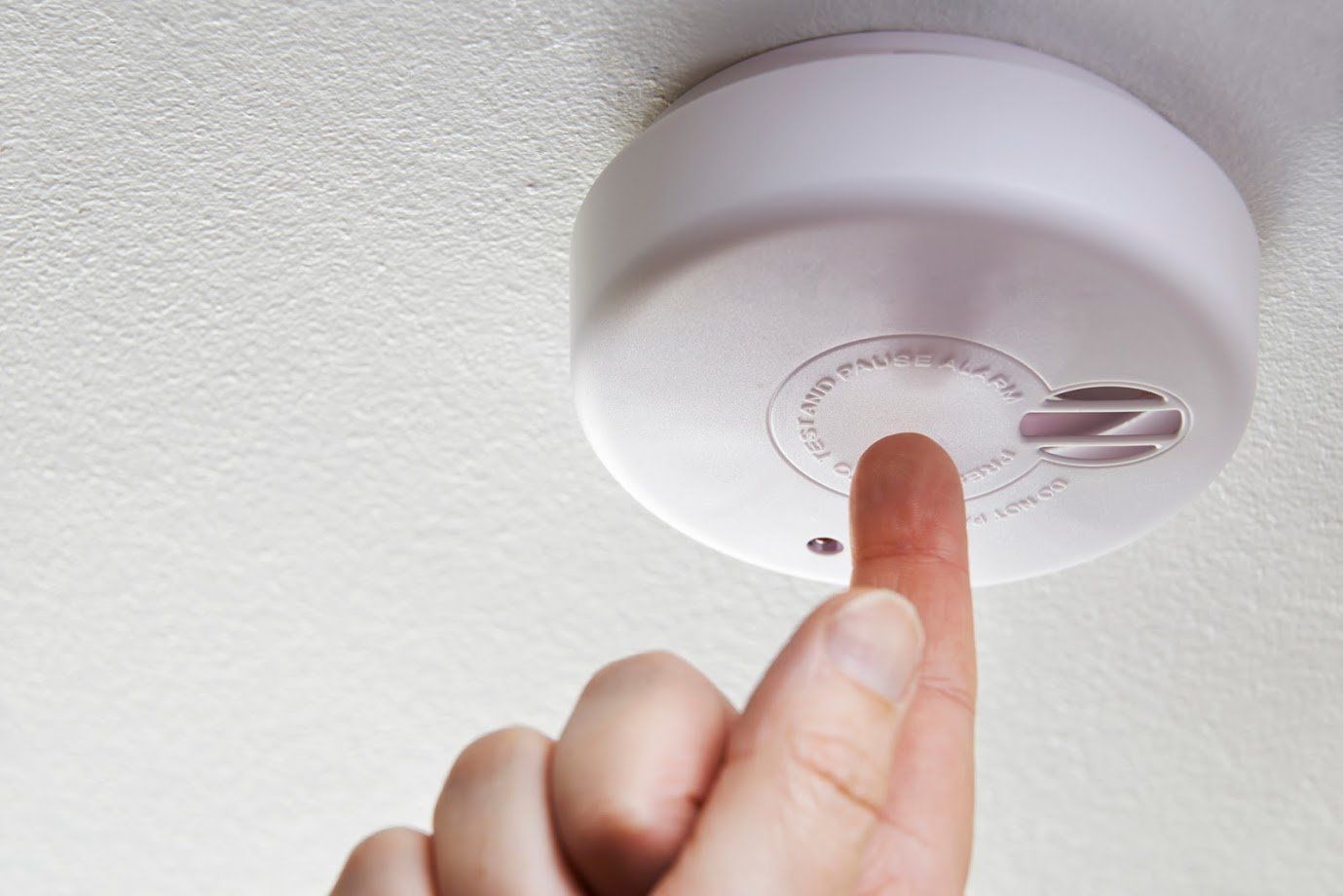 Clean Air Systems — Close Up Of Hand Testing Domestic Smoke Alarm in Knoxville, TN