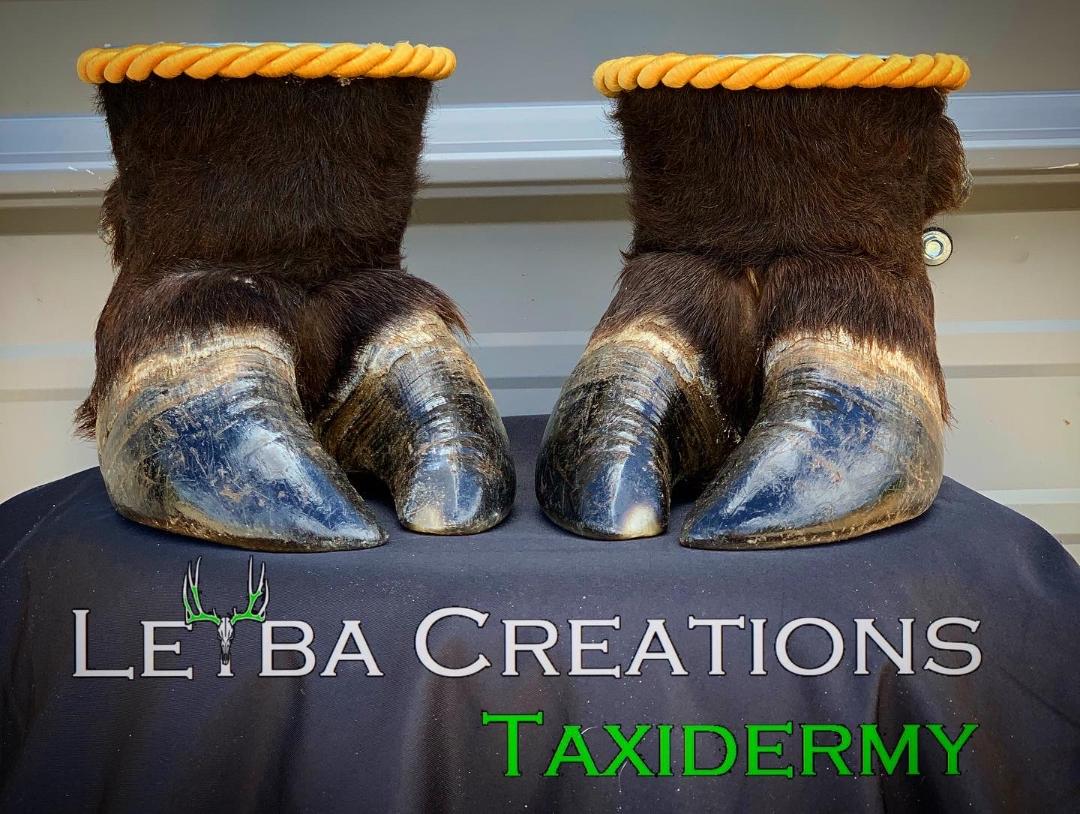 A pair of boots made out of horse hooves are sitting on a table.