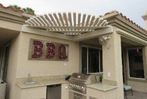 A house with a grill and a sign that says BBQ on it.