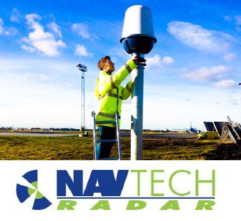 Technician installing a NAVtech radar unit outdoors under a blue sky