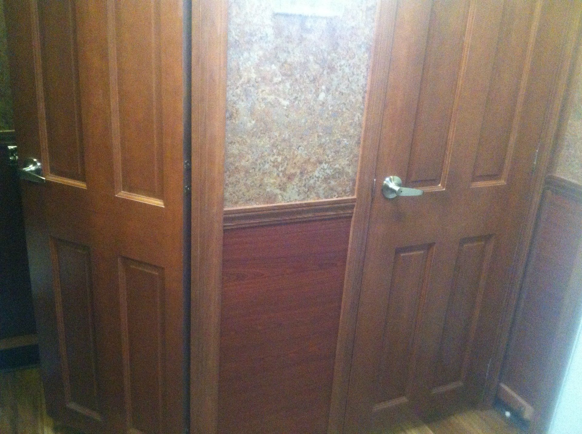A close up of a wooden door with a glass window