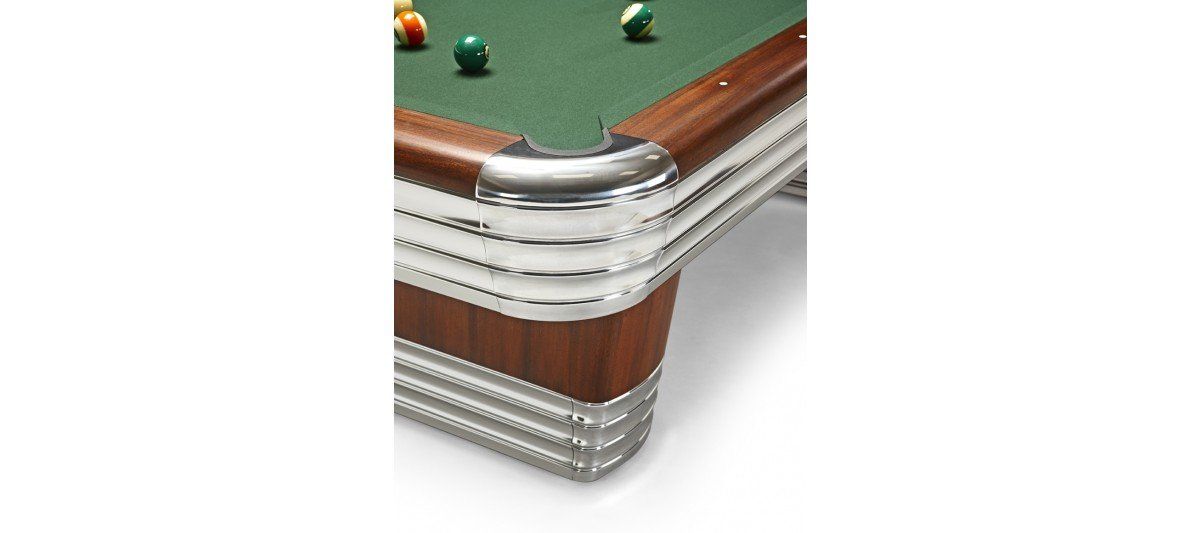 Cross-section of a billiards table corner showing layers of wood, felt, and metal trim.