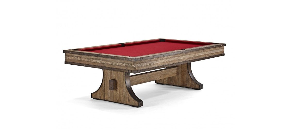 Red-felt billiards table with wooden legs and trim on a white background